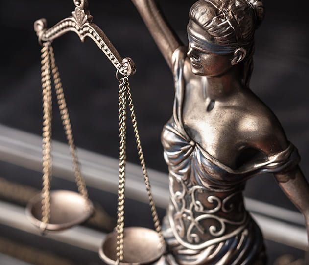A bronze statue representing justice with scales, symbolizing business law.