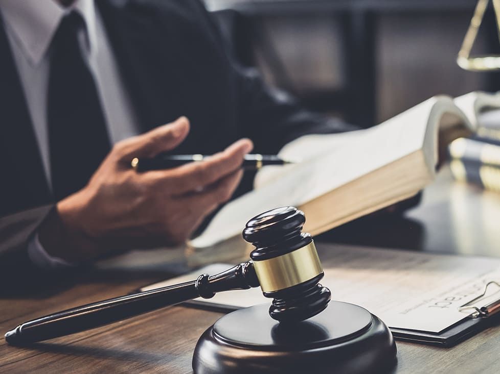 A lawyer preparing for a case with a gavel and law book.