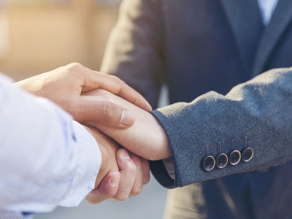 Close-up of two hands shaking in a business context