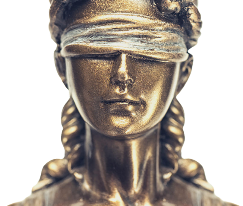 Detailed view of a bronze statue of Lady Justice, featuring a blindfold and intricate design.