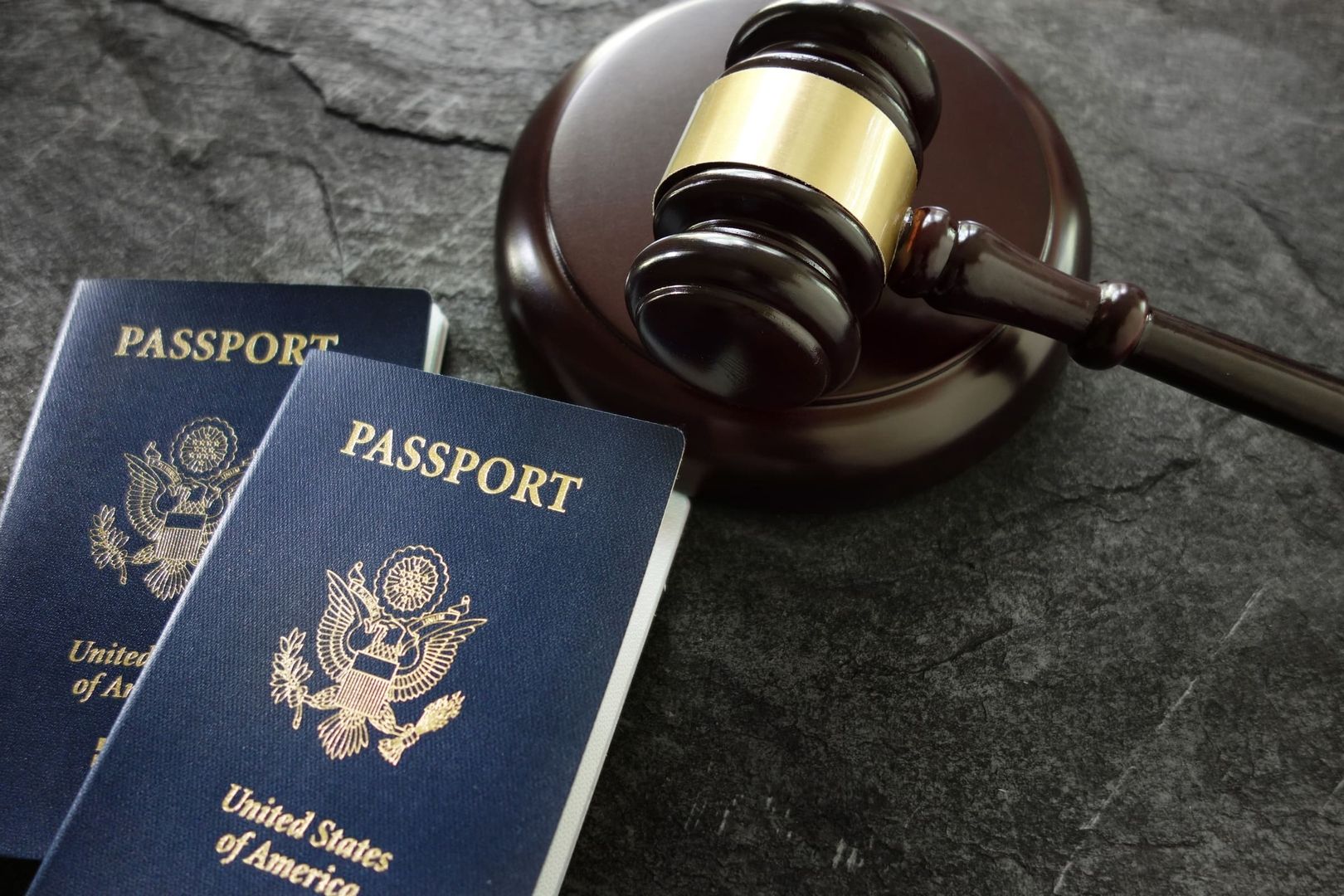Judicial elements including a gavel and passports related to citizenship law.