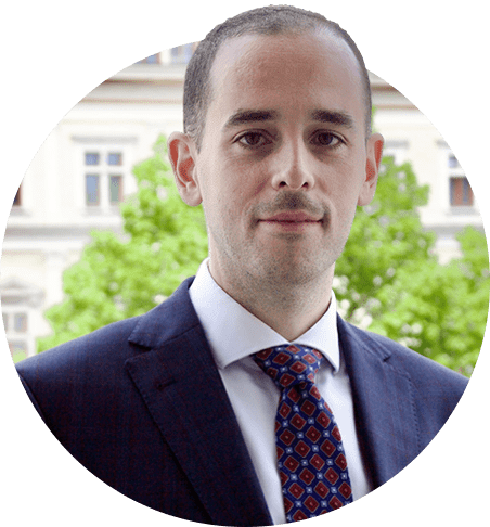 Lawyer Dr. Farah Abu-Jurji in a formal suit against a blurred background.