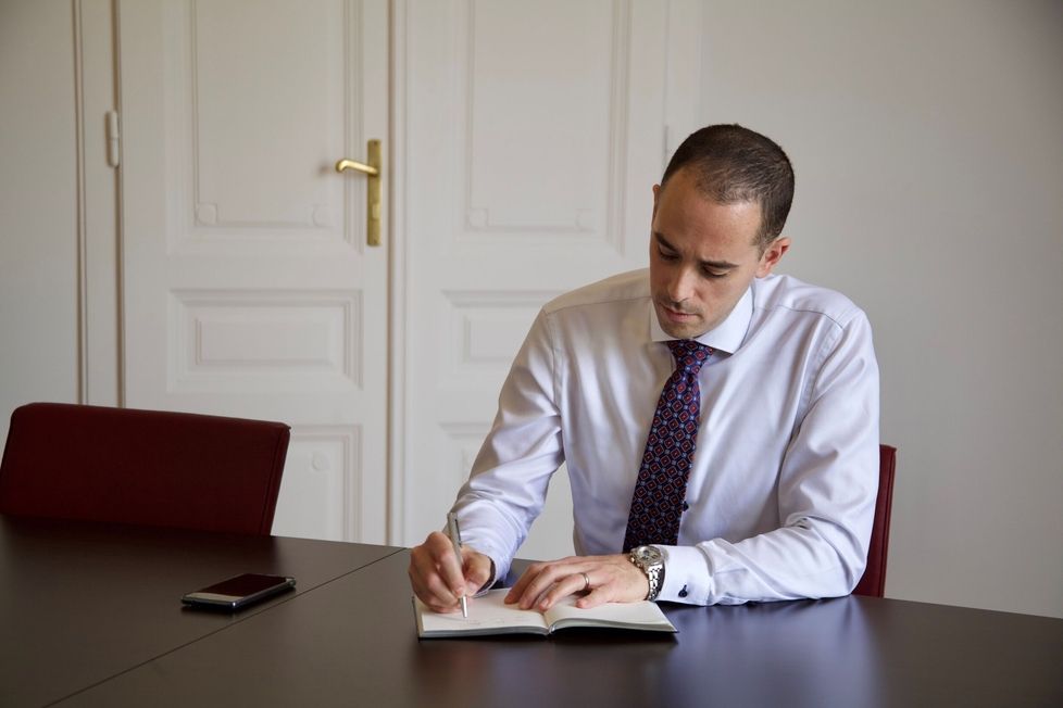 Lawyer Dr. Farah Abu-Jurji in his office in Vienna, focused on work.